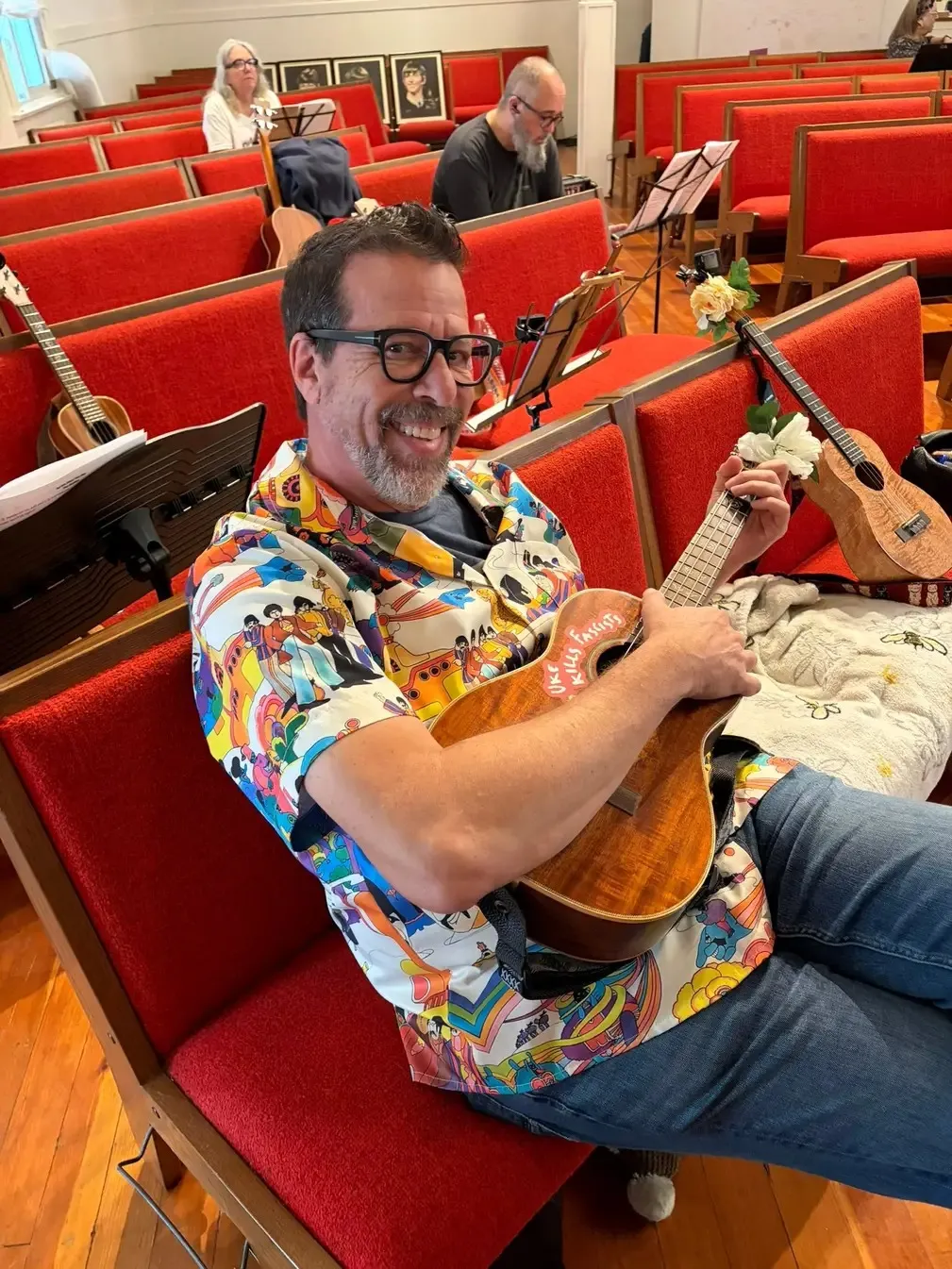 A player stretched out along the pews with a koa ukulele