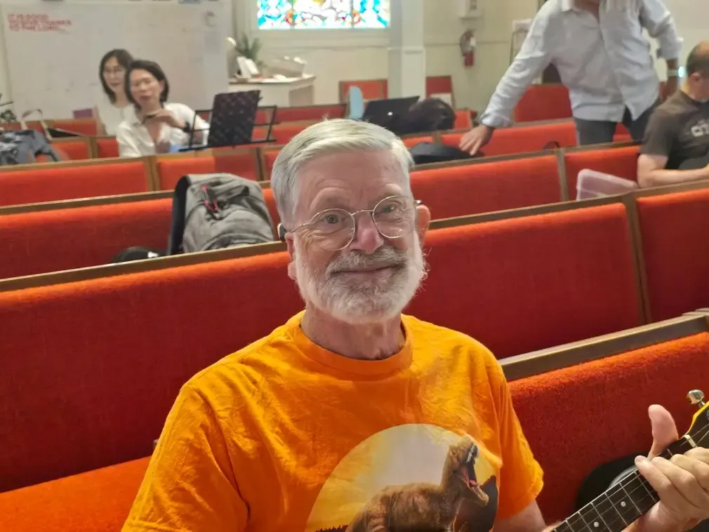 A player in an orange shirt in the red pews